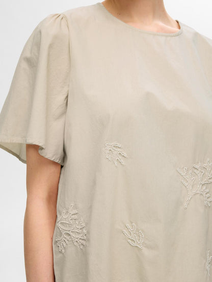 Beige top embroidered detail